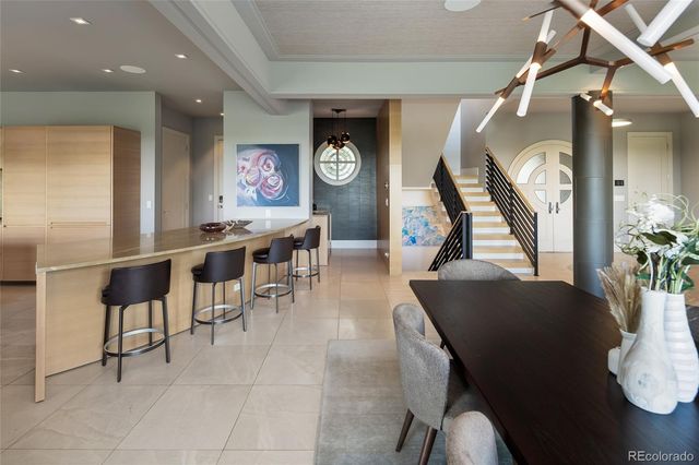 a living room with furniture a window and a chandelier