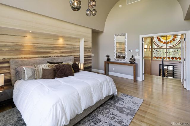 a bedroom with a bed a table and chair