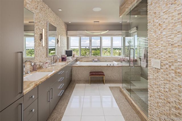 a large bathroom with a large tub and sink