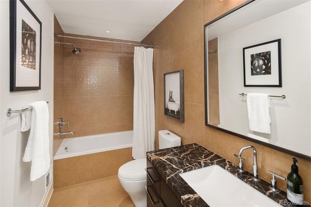 a spacious bedroom with a bed and wooden floor