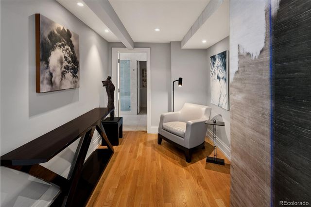 a large bedroom with a bed and a large window with wooden floor