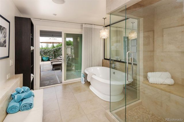 a bathroom with a tub a sink and a mirror