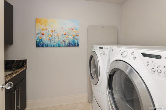 a view of a patio with couches table and chairs with wooden floor and fence