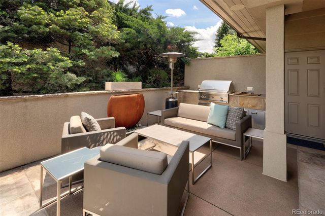 a view of a backyard with table and chairs and a fire pit