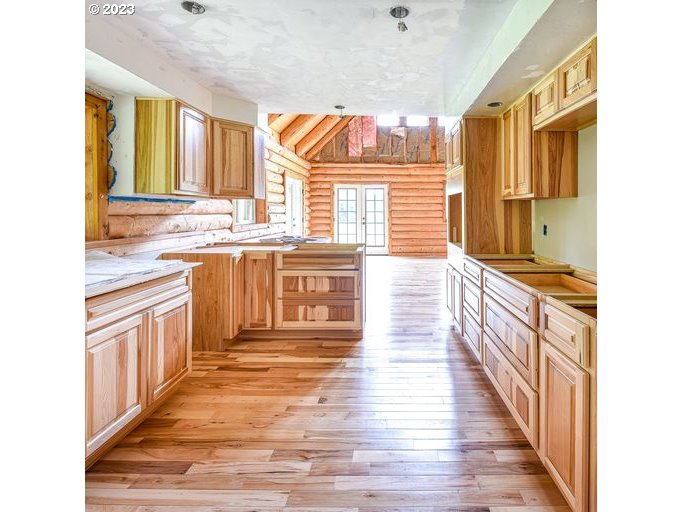 72717 London Road Cottage Grove, OR 97424 - Photo 17 of 41 a kitchen with stainless steel appliances granite countertop a stove a sink and a wooden floors