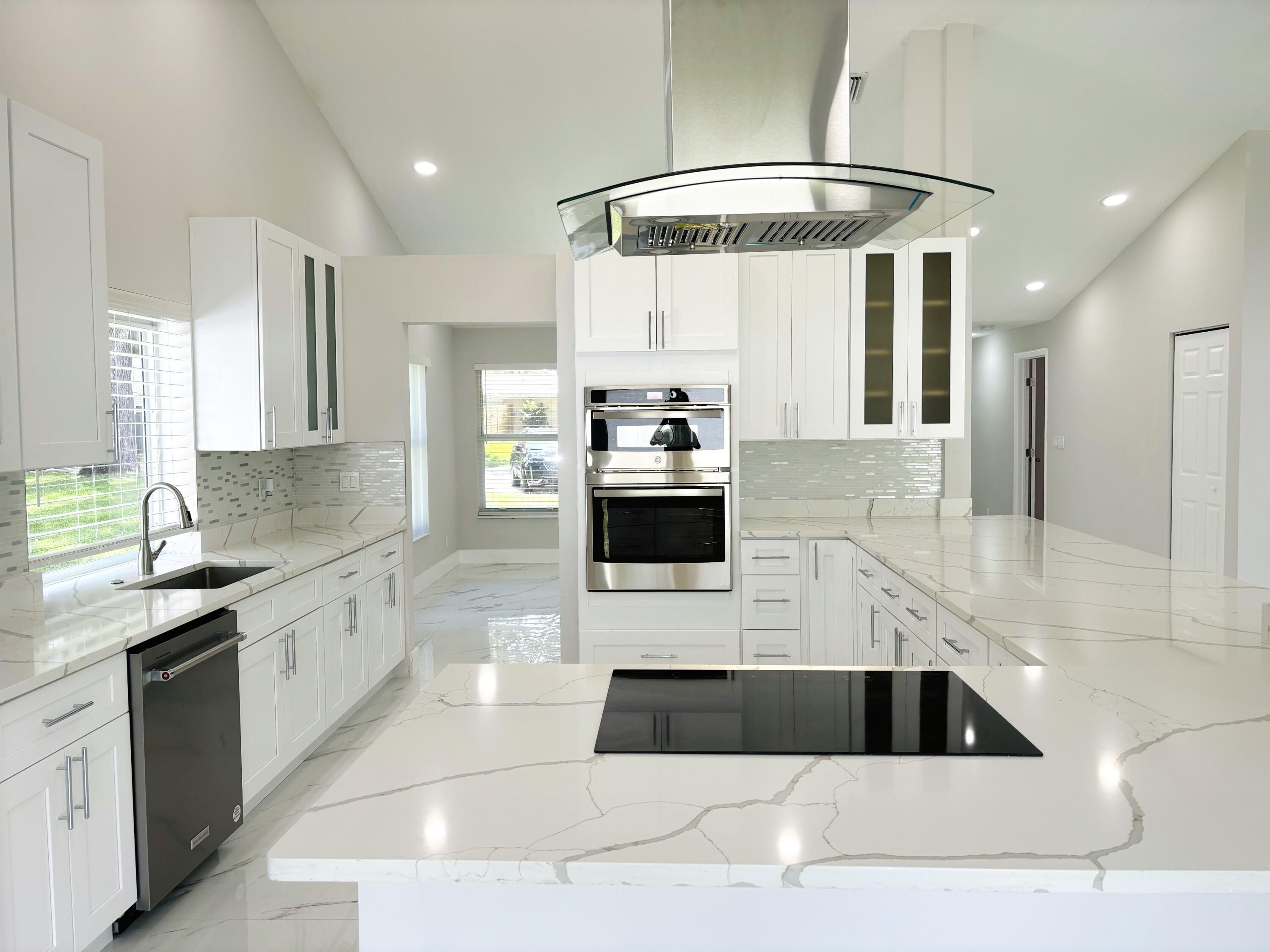 a kitchen with a sink a stove and cabinets