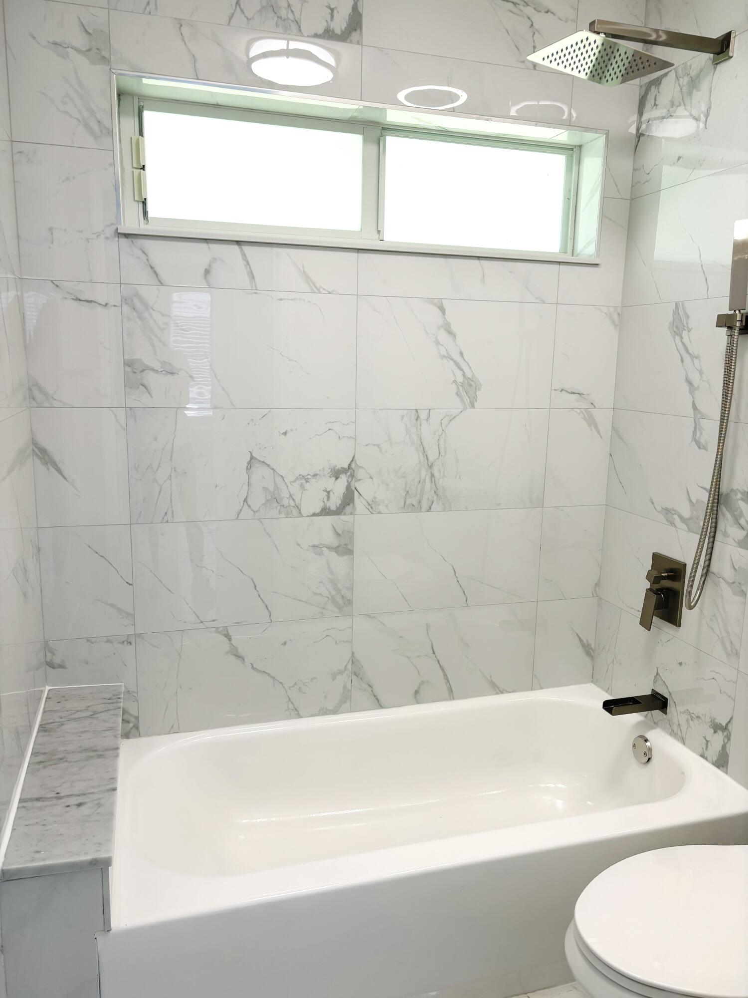 1341 West Royal Palm Road Boca Raton, FL 33486 - Photo 14 of 19 a bathroom with a bathtub and a toilet