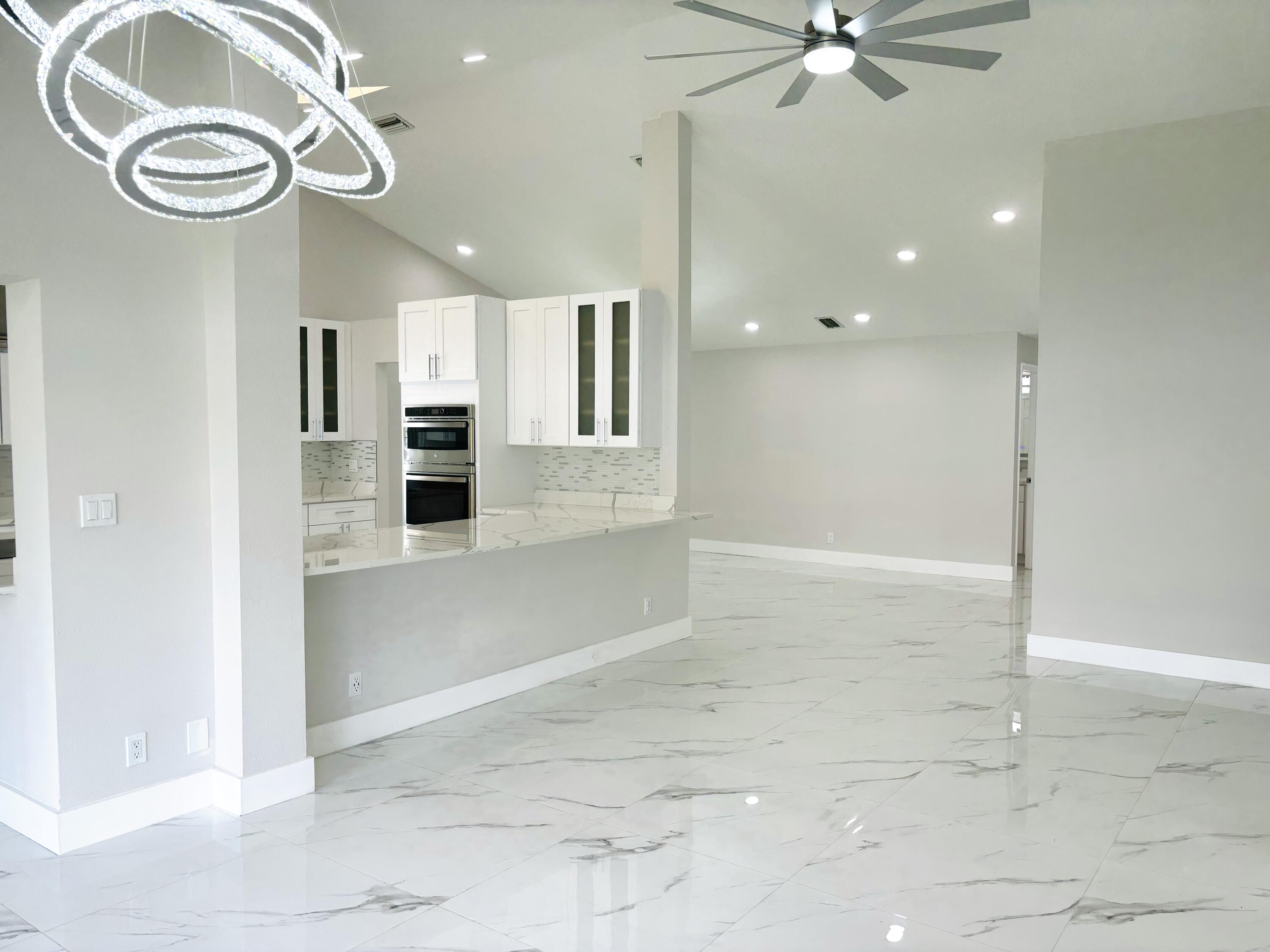 1341 West Royal Palm Road Boca Raton, FL 33486 - Photo 4 of 19 a view of a hallway with a kitchen