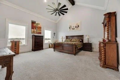a living room with furniture and a ceiling fan