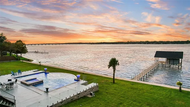 a kitchen that has a lot of cabinets in it and wooden floors