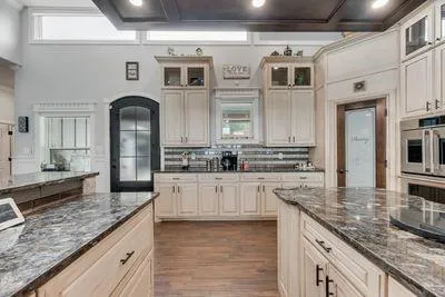 a living room with furniture large windows and a fireplace