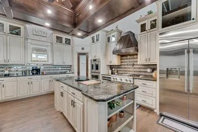 a kitchen with a stove a sink and a refrigerator