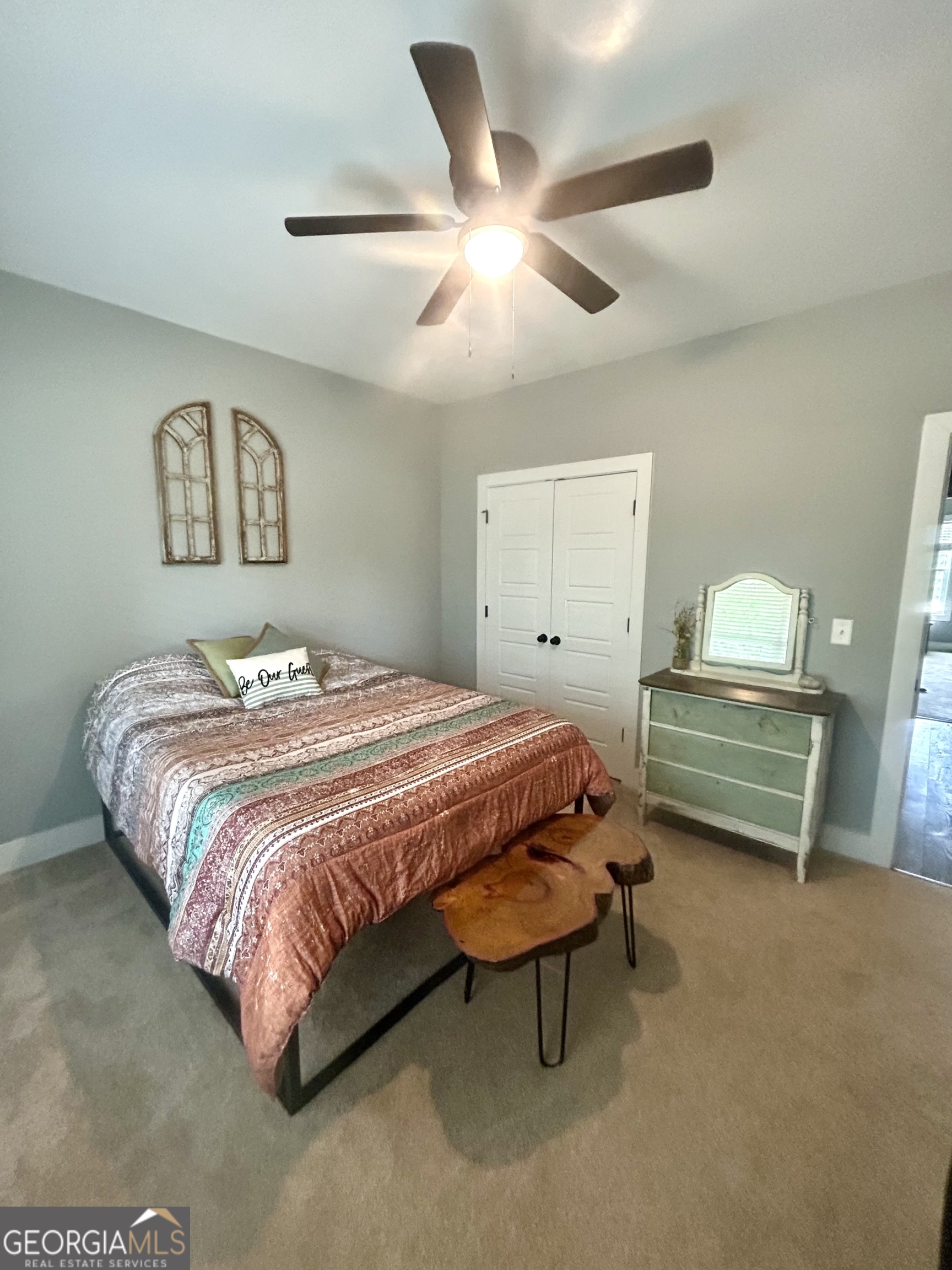1250 Godfrey Road Madison, GA 30650 - Photo 27 of 42 a bedroom with a bed and a chandelier