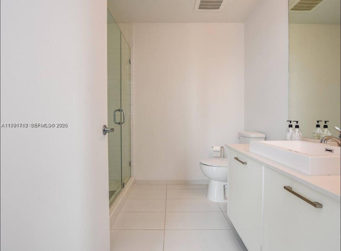 151 Southeast 1st Street, Unit 2104 Miami, FL 33131 - Photo 11 of 29 a bathroom with a sink a toilet and shower