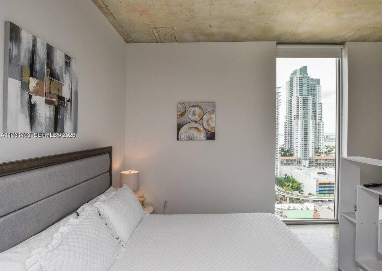151 Southeast 1st Street, Unit 2104 Miami, FL 33131 - Photo 12 of 29 a bedroom with a bed and a window