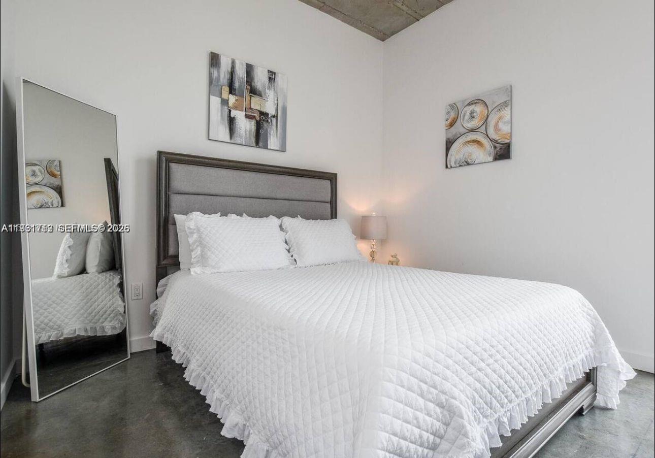 151 Southeast 1st Street, Unit 2104 Miami, FL 33131 - Photo 15 of 29 a bedroom with a bed and painting on the wall