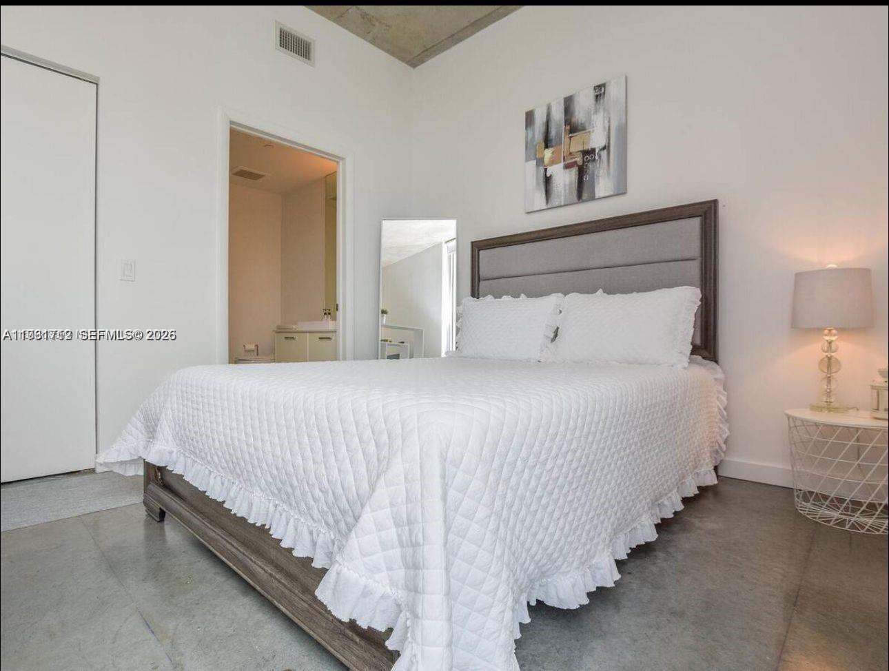 151 Southeast 1st Street, Unit 2104 Miami, FL 33131 - Photo 17 of 29 a bedroom with bed and a night stand