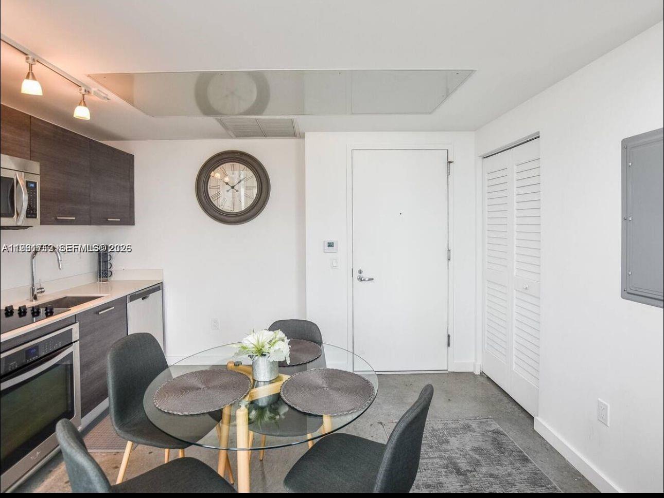 151 Southeast 1st Street, Unit 2104 Miami, FL 33131 - Photo 22 of 29 a view of a kitchen area with furniture and wooden floor