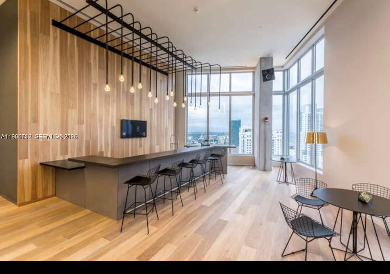 151 Southeast 1st Street, Unit 2104 Miami, FL 33131 - Photo 7 of 29 a living room with furniture and large windows