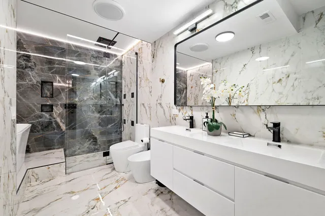 a bathroom with a sink toilet and shower