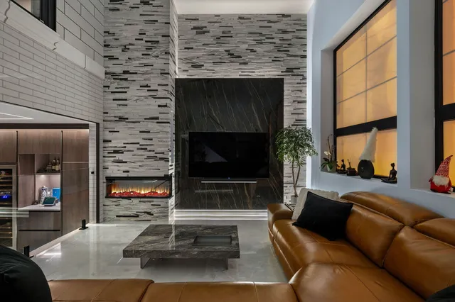 a living room with furniture a fireplace and a flat screen tv