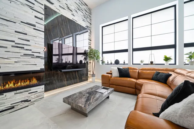 a living room with furniture a floor to ceiling window and a flat screen tv