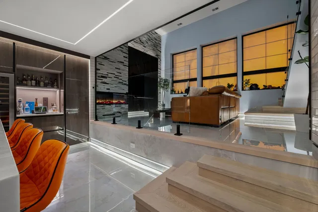 a living room with furniture and a floor to ceiling window