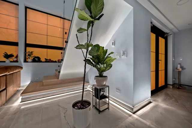 a vase of flowers sitting on a table with window
