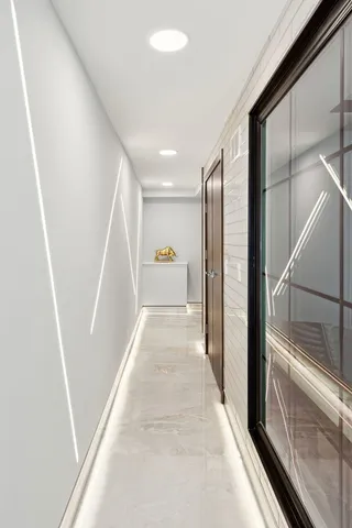 a view of hallway with stairs and wooden floor