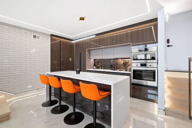 a kitchen with stainless steel appliances granite countertop a sink and a refrigerator