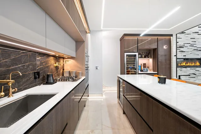 a large kitchen with kitchen island a sink and wooden floor