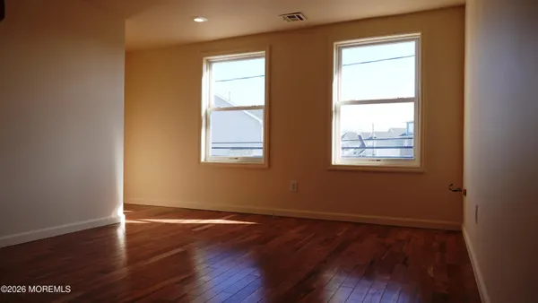 an entryway and stairs with wooden floor