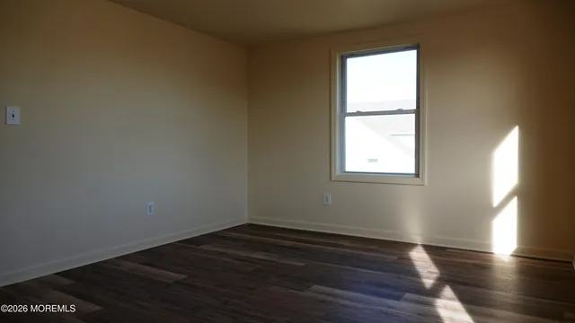 a view of dirt yard with a large tree