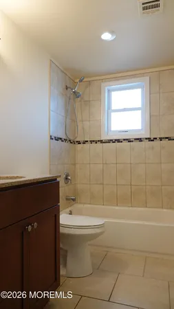 a bathroom with a sink a toilet and bathtub