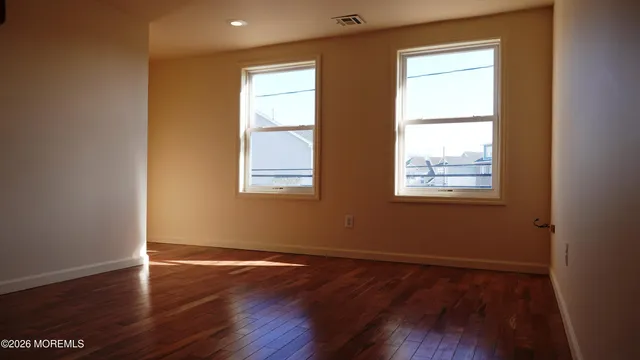 an entryway and stairs with wooden floor