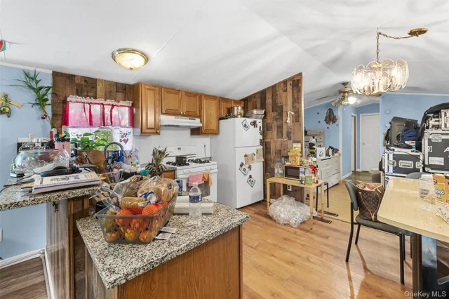 a view of a kitchen with dining table and chairs