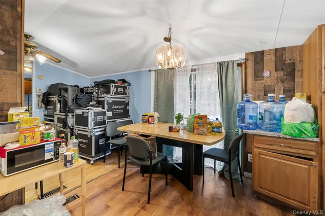 a view of a dining room with furniture wooden floor and chandelier