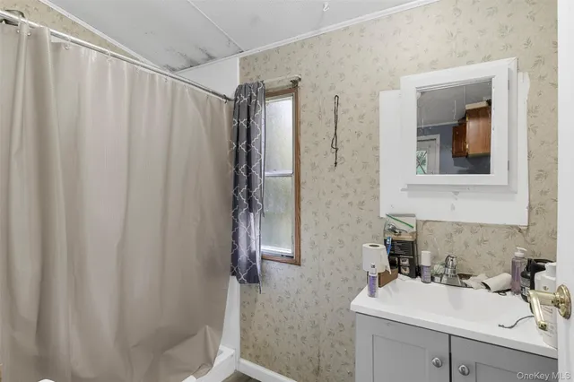 a view of a workspace with furniture and a flat screen tv