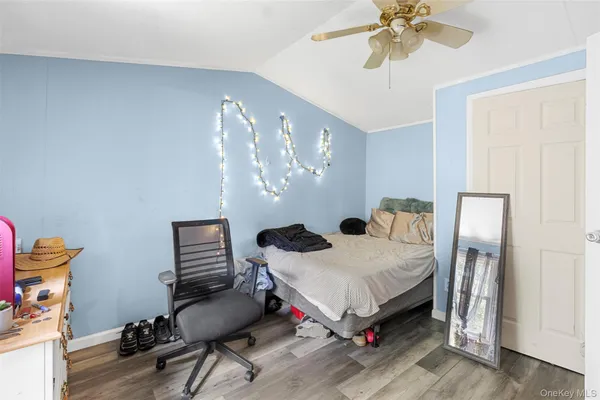 a bedroom with a bed window and a flat screen tv