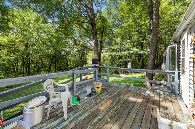 a view of a chairs and table on the wooden deck