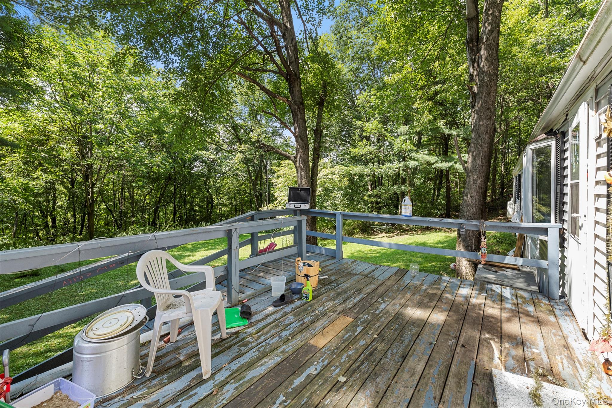 172 Orange Lake Road Walden, NY 12586 - Photo 5 of 22 a view of a chairs and table on the wooden deck