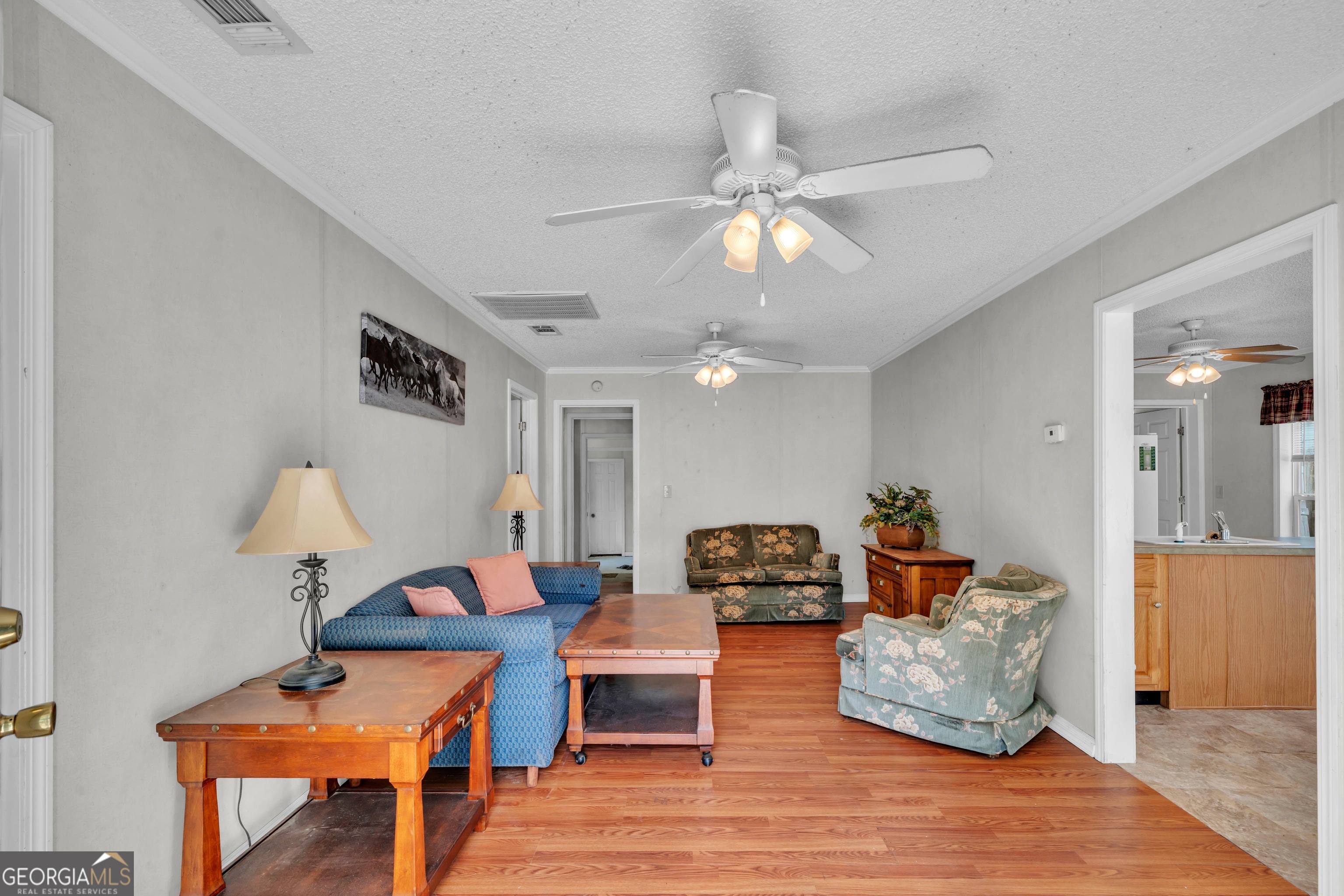 87 Georgia Avenue Adrian, GA 31002 - Photo 64 of 74 a living room with furniture and a chandelier