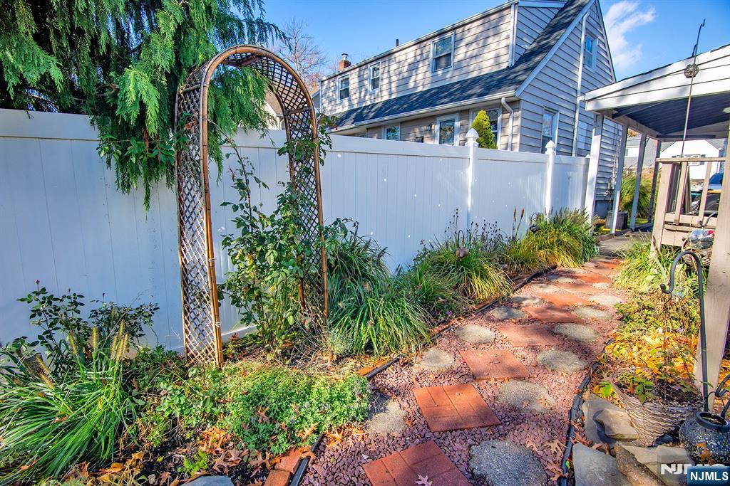 96 Porter Avenue Bergenfield, NJ 07621 - Photo 17 of 18 a view of street along with house and trees in the background
