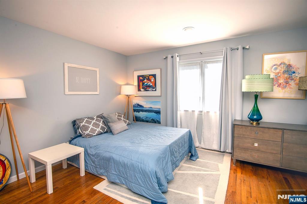 96 Porter Avenue Bergenfield, NJ 07621 - Photo 8 of 18 a bedroom with a bed and a tv on table