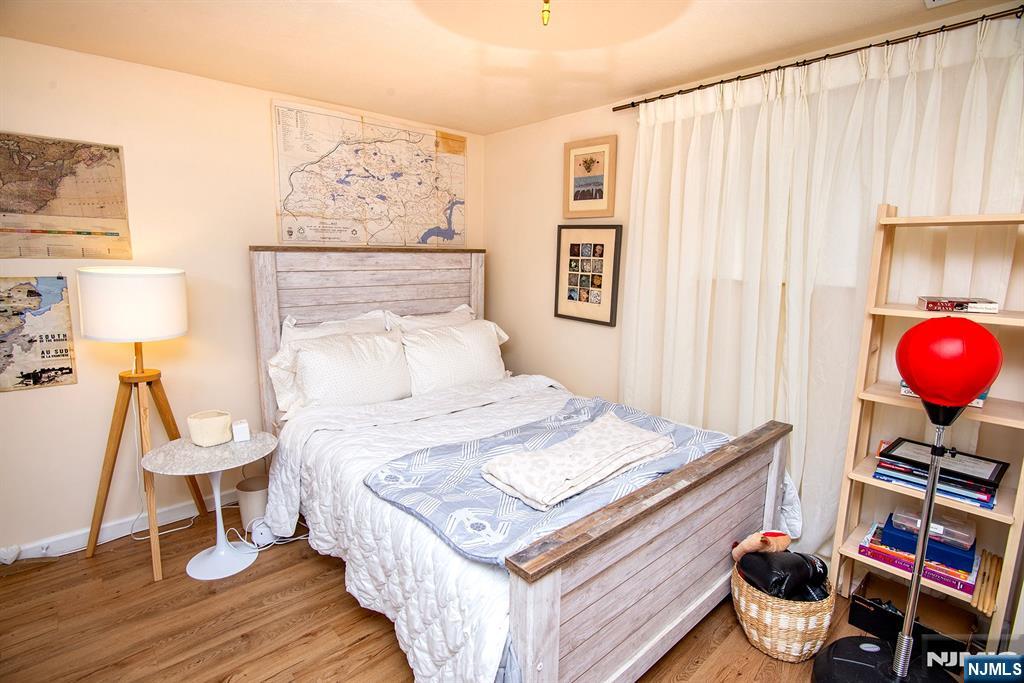 96 Porter Avenue Bergenfield, NJ 07621 - Photo 10 of 18 a bedroom with a bed and wooden floor