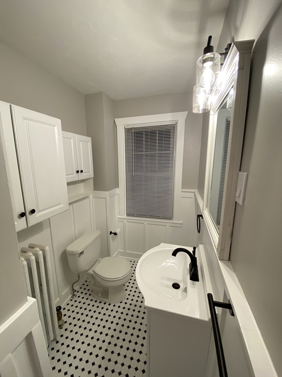 91 Main, Unit 2W Easton, MA 02356 - Photo 10 of 10 a bathroom with a sink a toilet a mirror and shower
