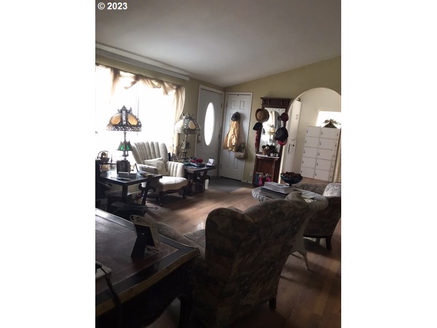 210 Quail Drive Spray, OR 97874 - Photo 3 of 6 a living room with furniture and floor to ceiling window