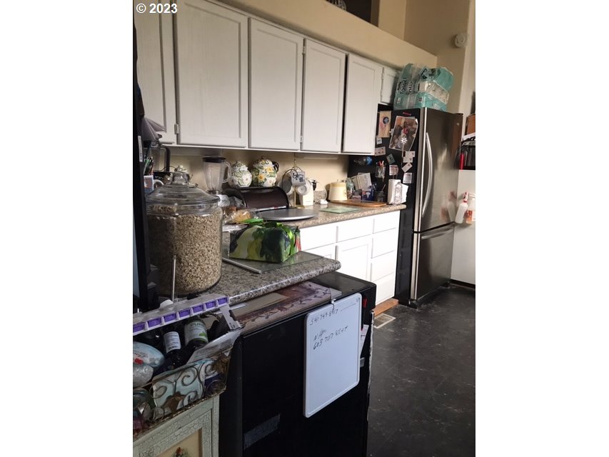 210 Quail Drive Spray, OR 97874 - Photo 4 of 6 a kitchen with a refrigerator and a stove