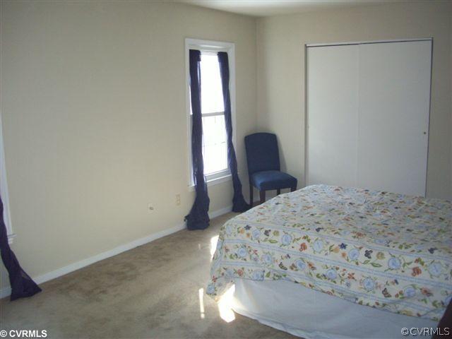 2925 Shiloh Church Road Midlothian, VA 23112 - Photo 6 of 11 a bedroom with a bed a chair and next to a window