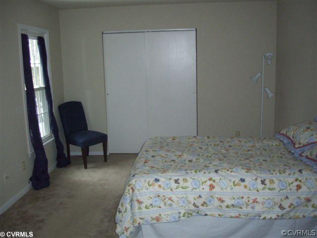 2925 Shiloh Church Road Midlothian, VA 23112 - Photo 7 of 11 a bedroom with a bed and a chair